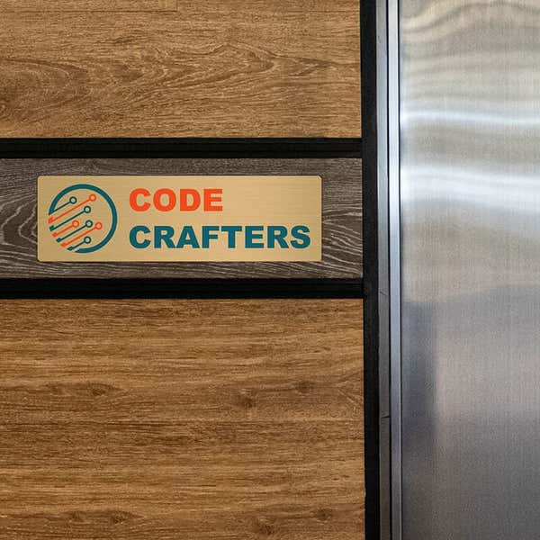 3x10 printed brass sign displayed on a wooden wall