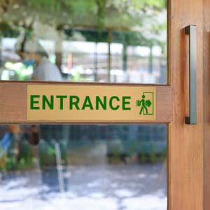 3x12 printed brass sign displayed on a front door