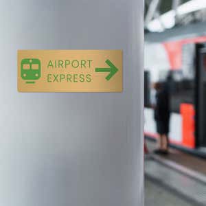 4x10 printed brass sign displayed by a train station