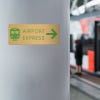4x10 printed brass sign displayed by a train station