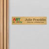 4x18 printed brass sign displayed by a doorway