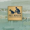 4x4 printed brass sign displayed on a fence