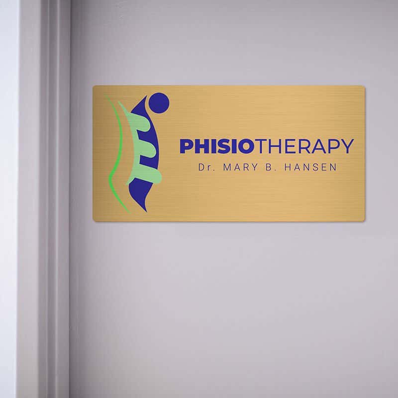 6x12 printed brass sign displayed by a doorway