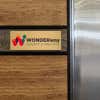 6x16 printed brass sign displayed on a wooden wall