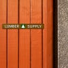 1" x 8" custom plastic sign displayed on a wooden wall