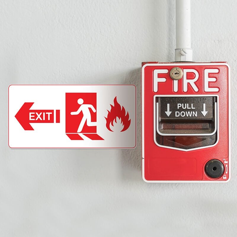 A fire exit sign with an arrow pointing left