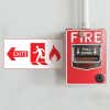 A fire exit sign with an arrow pointing left