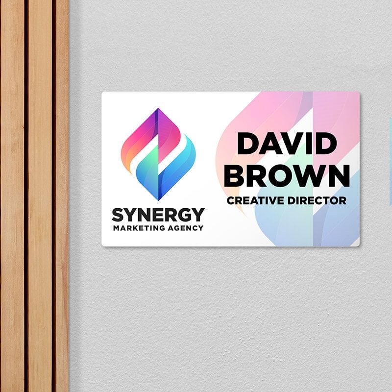 A plastic sign for an office with the employee name and position