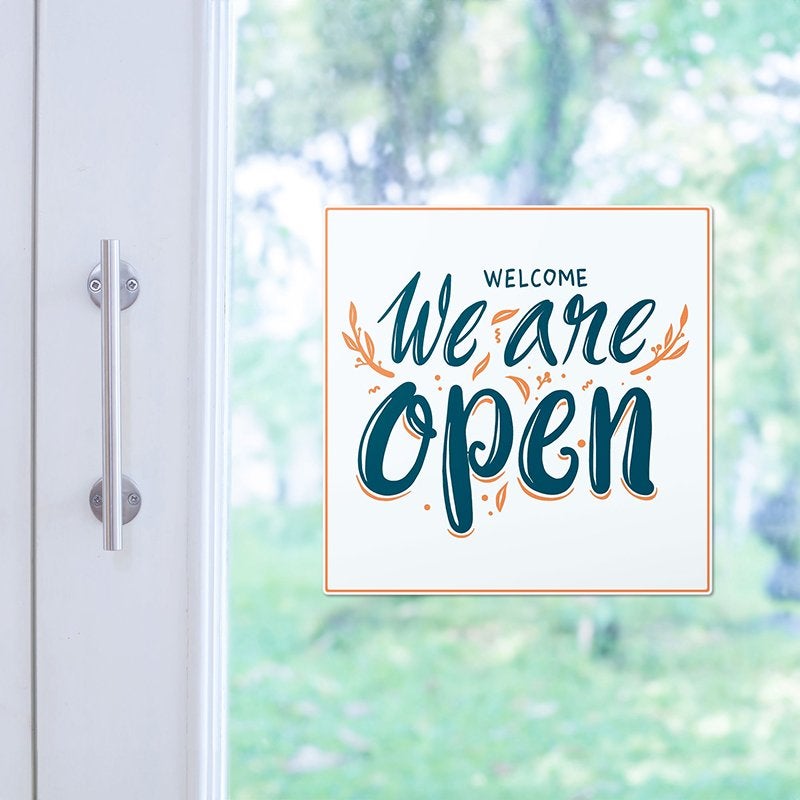 An open sign on the storefront window of a shop