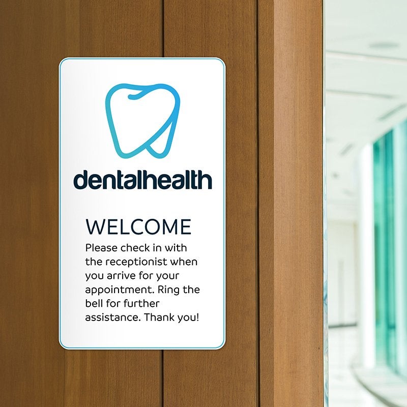 A dental health plastic sign with check in instructions
