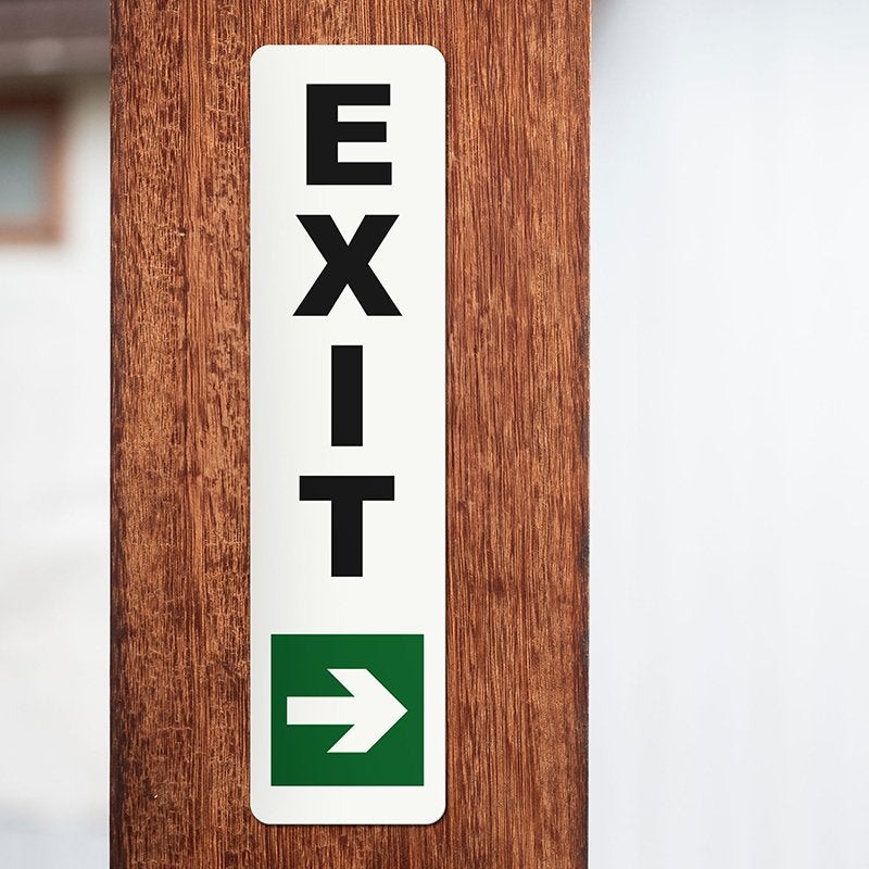 An exit sign on a wooden post