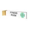 2” x 10” Corridor sign with white material color, black engraved text, logo, and gold holder on a white background with custom text saying “FITNESS ROOM”.