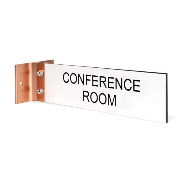 2” x 8” Corridor sign with white material color, black engraved text, and rose gold holder on a hallway wall with custom text saying “CONFERENCE ROOM”.