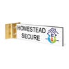 2” x 8” Corridor sign with white material color, black engraved text, logo, and gold holder on a white background with custom text saying “HOMESTEAD SECURE”.
