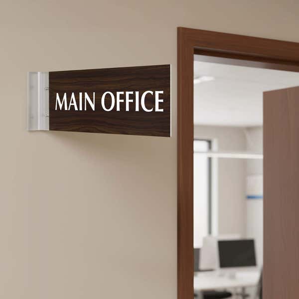 Main Office projection sign with walnut finish and silver holder installed on a door in an office hallway.