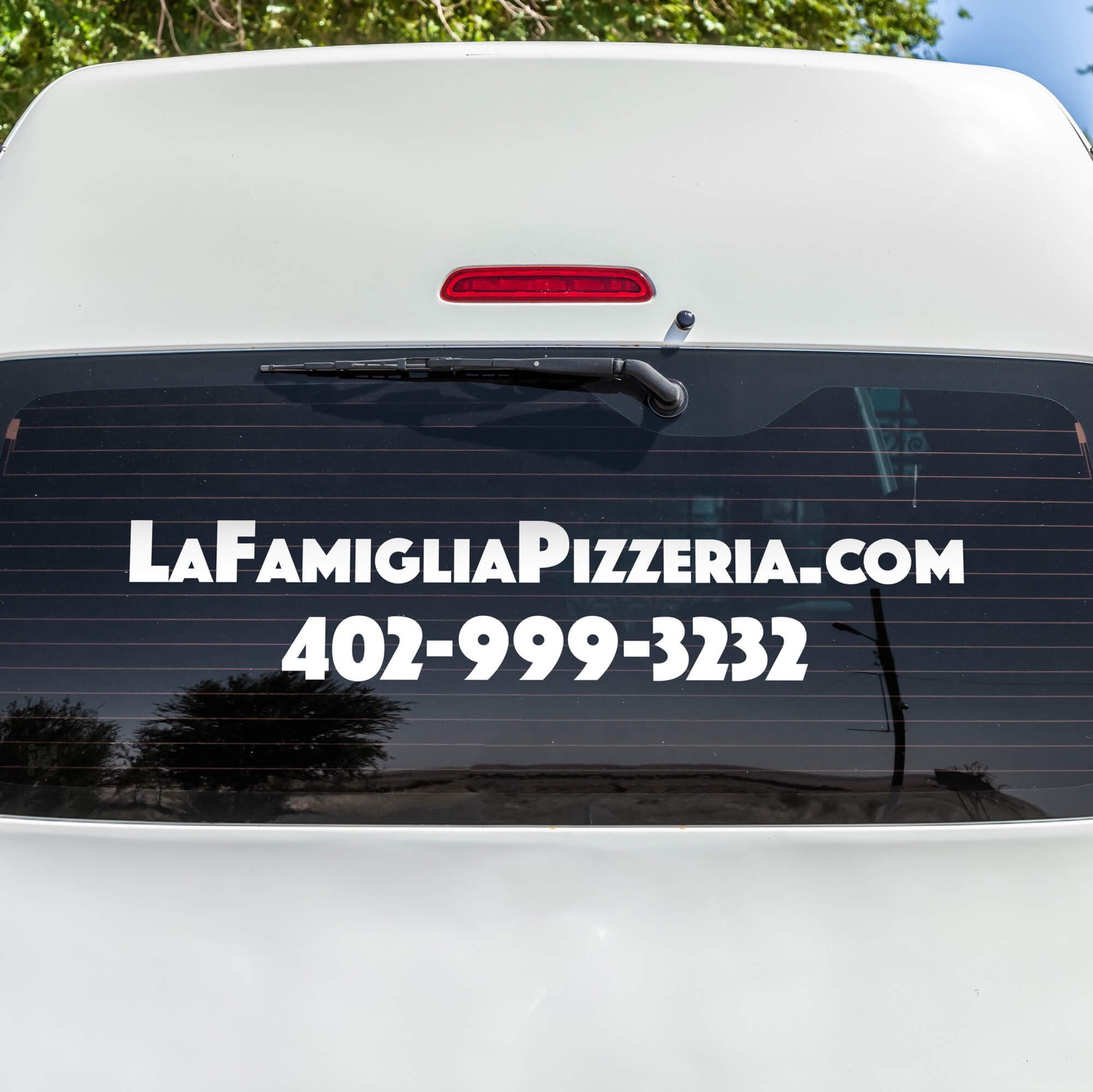 A vinyl decal on the rearview window for a pizza company