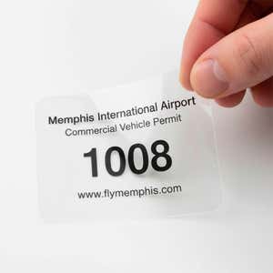 A clear window cling for an airport permit