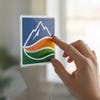 A small square window cling of a company logo