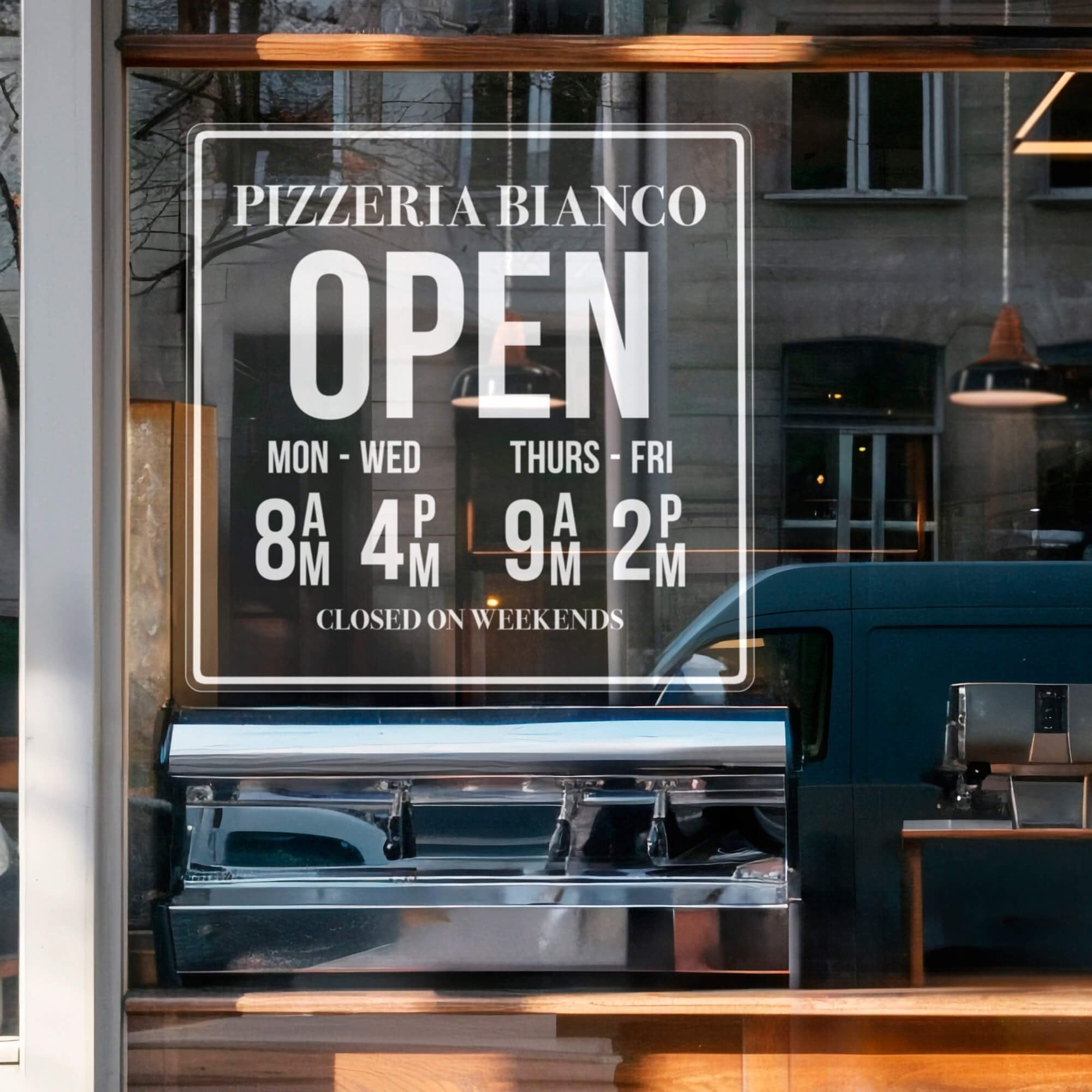A clear window cling for a pizzeria with their store hours