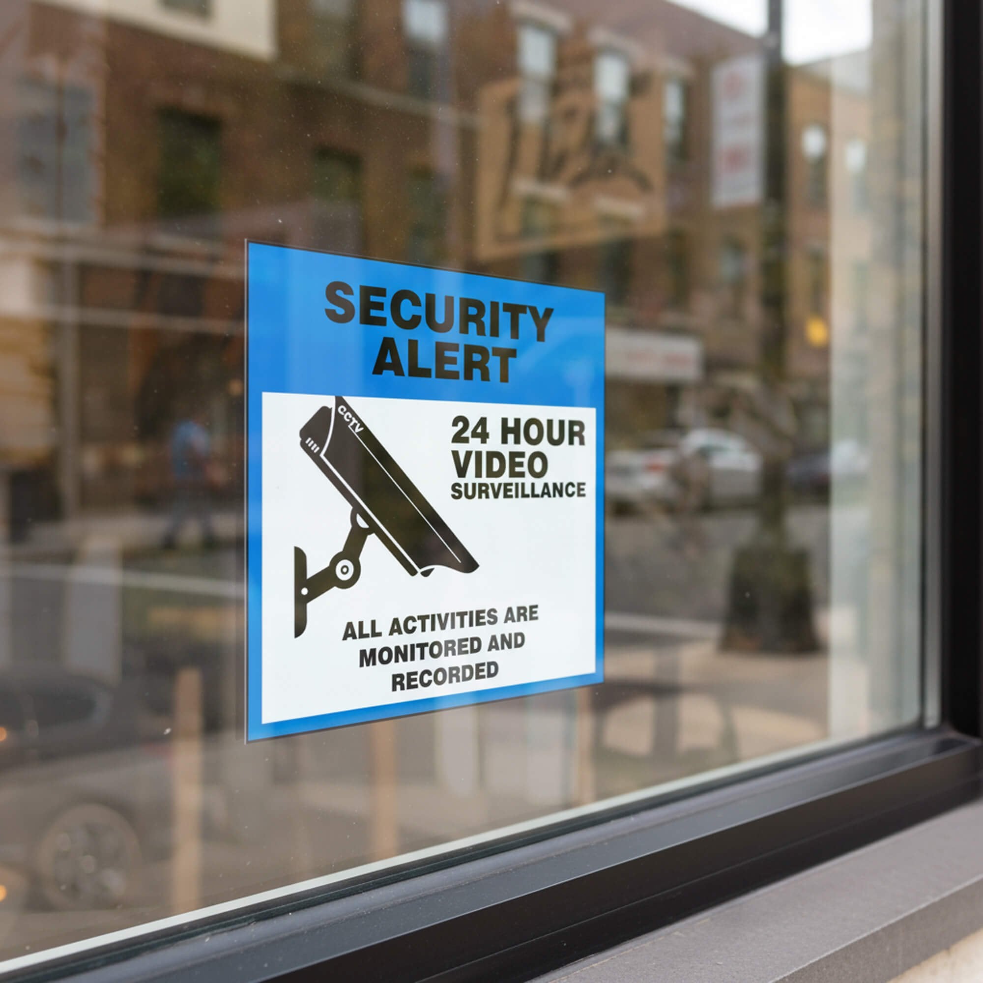 A window cling for a security camera on a storefront window