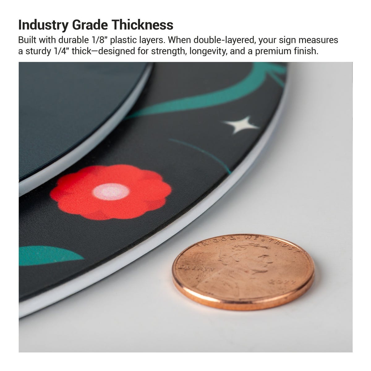 The thickness of the 2-layer round ADA sign compared to a US penny