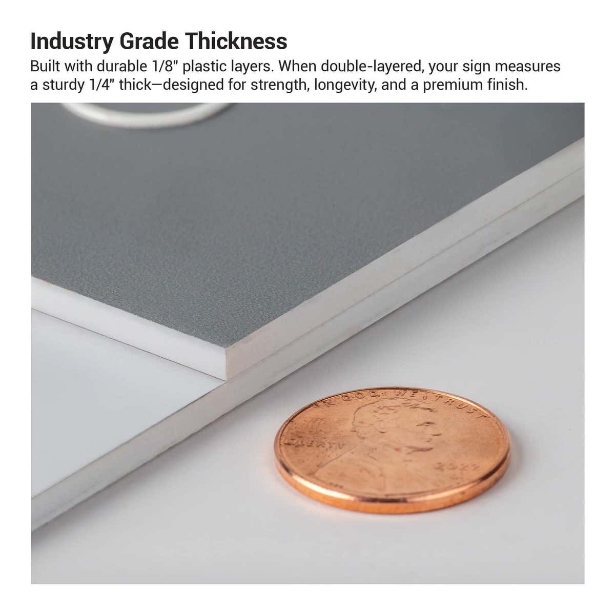 The thickness of the 2-layer round ADA sign compared to a US penny