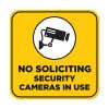 Yellow No Soliciting sign reading "Security Cameras in Use" with a security camera icon