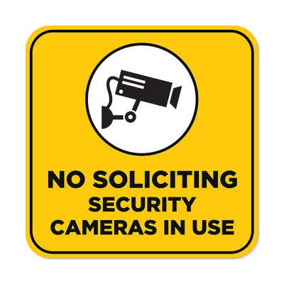 Yellow No Soliciting sign reading "Security Cameras in Use" with a security camera icon