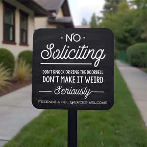 Funny no soliciting sign on yard stake in front yard reading, "Don’t make it weird, seriously"