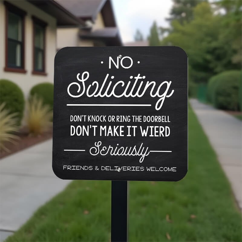 Funny no soliciting sign on yard stake in front yard reading, "Don’t make it weird, seriously"