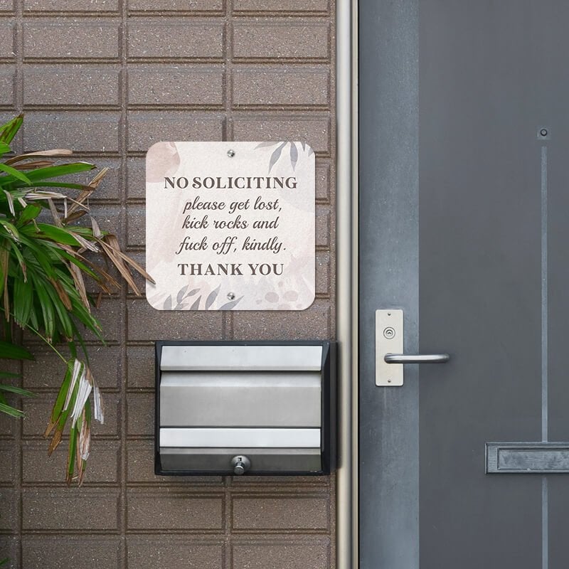 No soliciting sign hung up next to the front door reading, "Please get lost, kick rocks, and f* off kindly. Thank you."