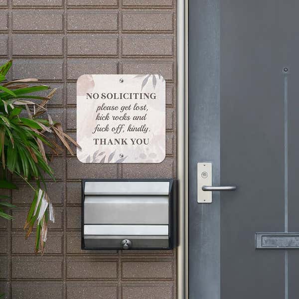 No soliciting sign hung up next to the front door reading, "Please get lost, kick rocks, and f* off kindly. Thank you."