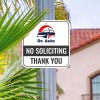 No soliciting sign with Dr. Auto car logo reading Thank you hung up on metal post
