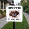 No soliciting sign with a custom pet photo reading, "See dog for details on a yard stake. 