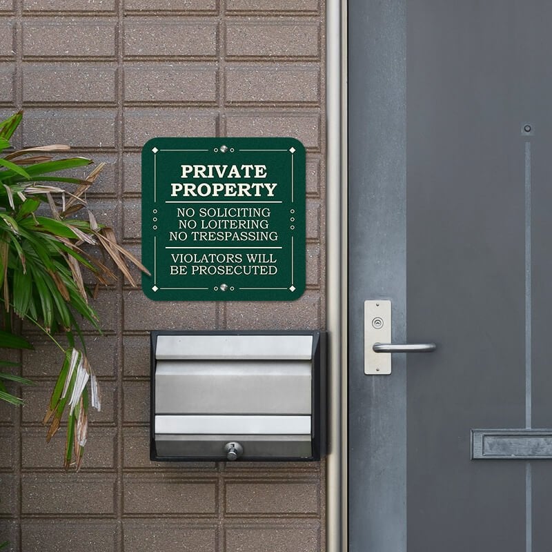 Private property, no soliciting. loitering or trespassing sign reading Violators will be prosecuted next to the front door