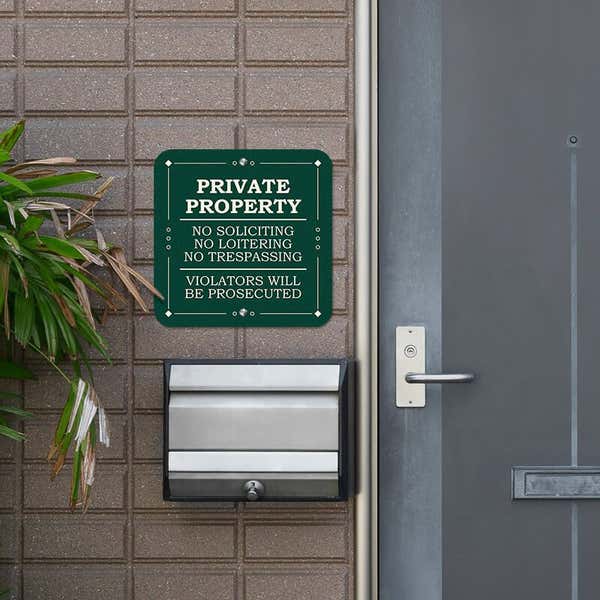 Private property, no soliciting. loitering or trespassing sign reading Violators will be prosecuted next to the front door