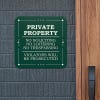 Green private property, no soliciting, no loitering, no trespassing sign reading Violators will be prosecuted hung on wall 