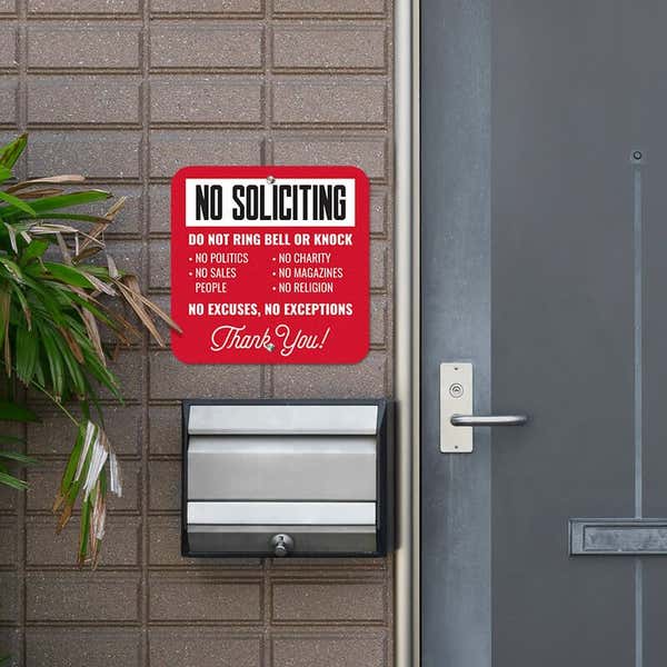 Red No soliciting sign. Do not ring bell or knock. No excuses, No exceptions in white text hung next to front door