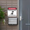 No soliciting warning sign, with a snake icon, hung next to the front door.