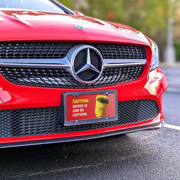Low On Caffeine front license plate on a red car