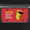 A close up of the Low On Caffeine front license plate on a black car