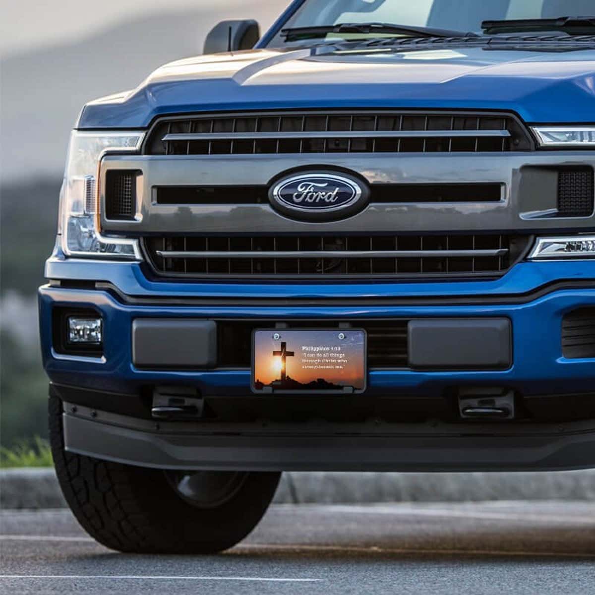 All Things Through Christ front license plate on a blue truck