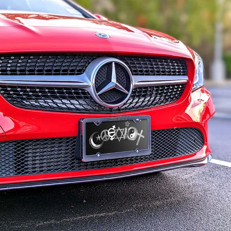 Coexist front license plate on a red car