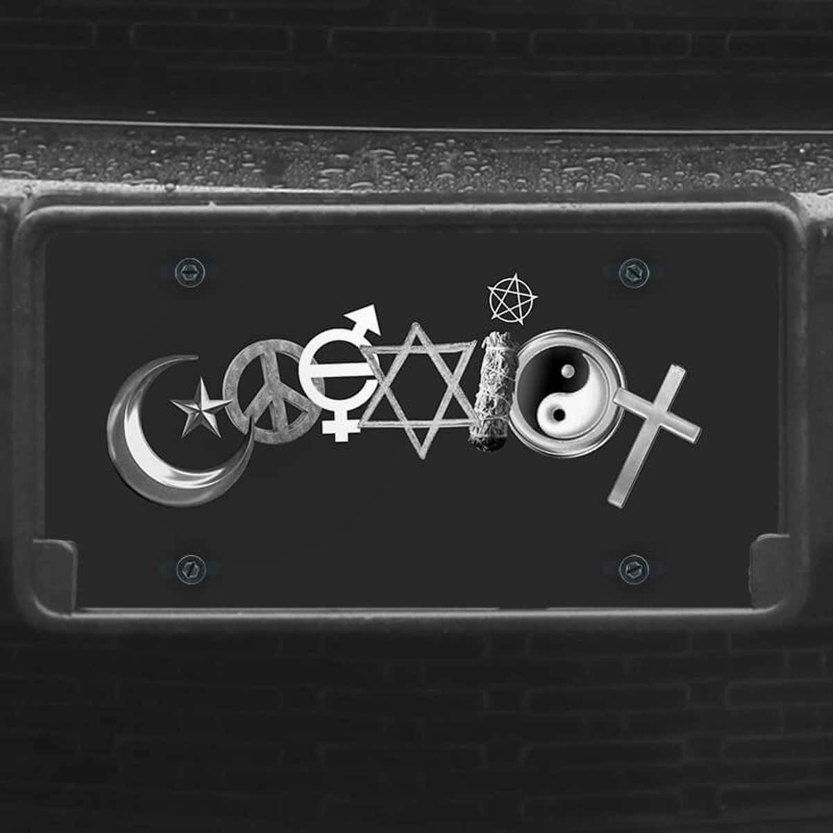 A close up of the Coexist front license plate on a black car