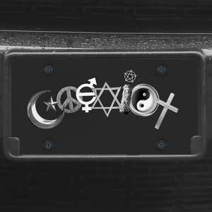 A close up of the Coexist front license plate on a black car