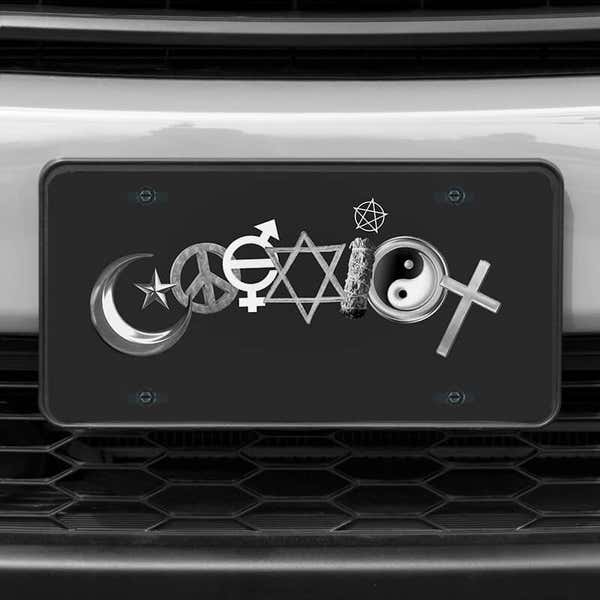 A close up of the Coexist front license plate on a white car