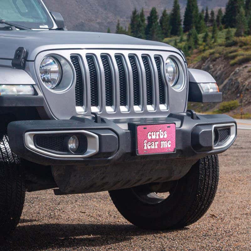 Curbs Fear Me front license plate on a Jeep