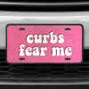 A close up of the Curbs Fear Me front license plate on a white car