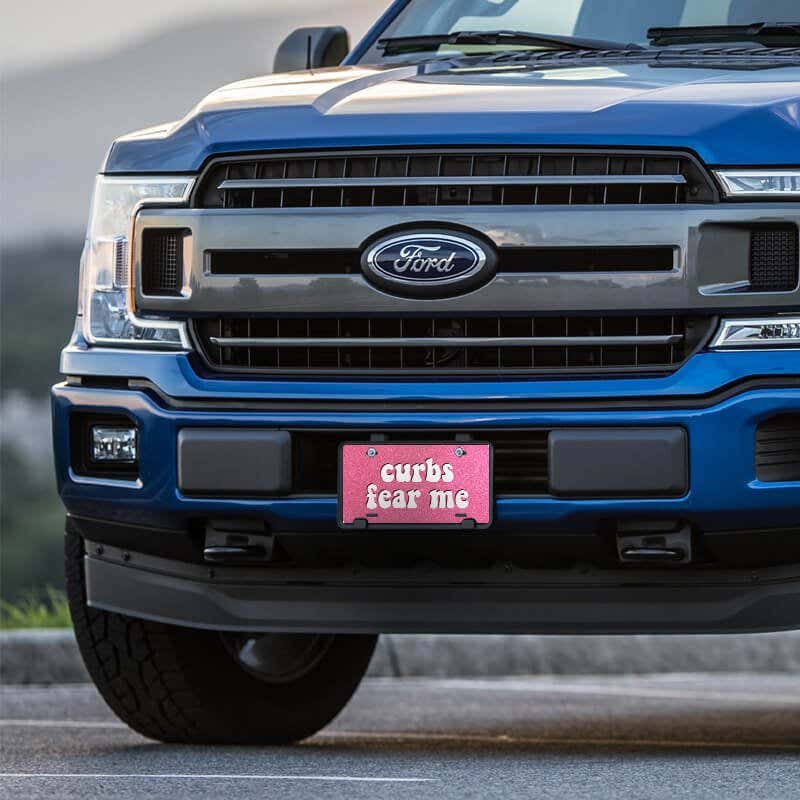 Curbs Fear Me front license plate on a blue truck