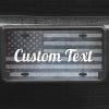 A close up of the Custom American Flag front license plate on a black car